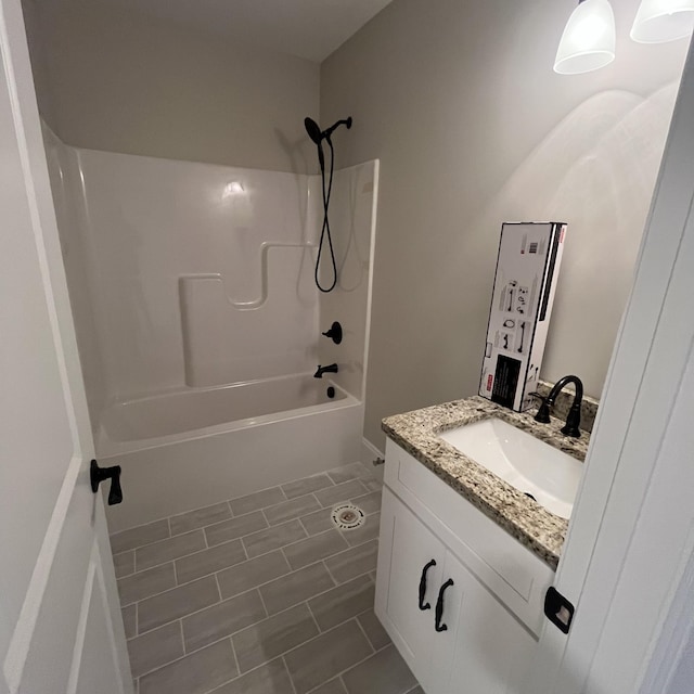 bathroom with shower / bathtub combination, tile patterned floors, and vanity