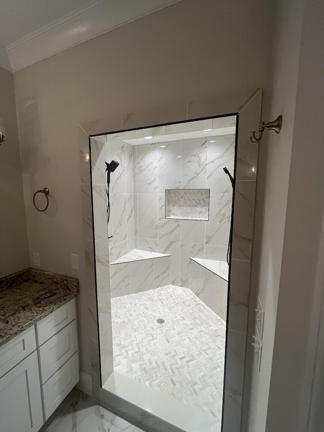 bathroom with tiled shower and ornamental molding