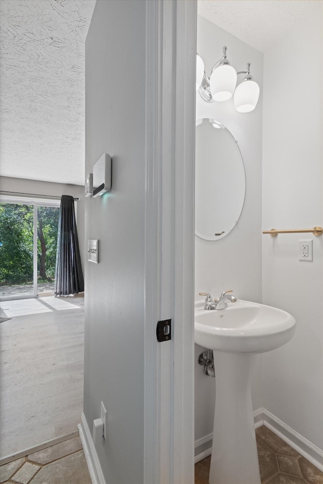 bathroom featuring tile patterned flooring and a textured ceiling