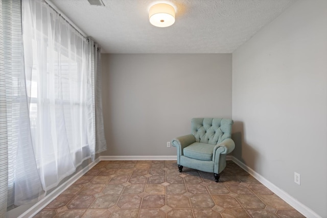 unfurnished room with a textured ceiling