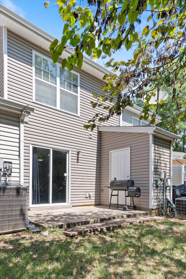 back of house with a patio area and central air condition unit