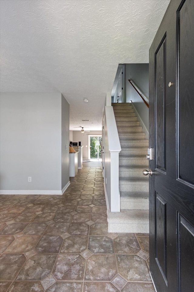 foyer with a textured ceiling