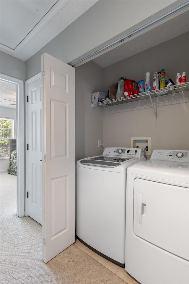 laundry room with light carpet and washer and clothes dryer