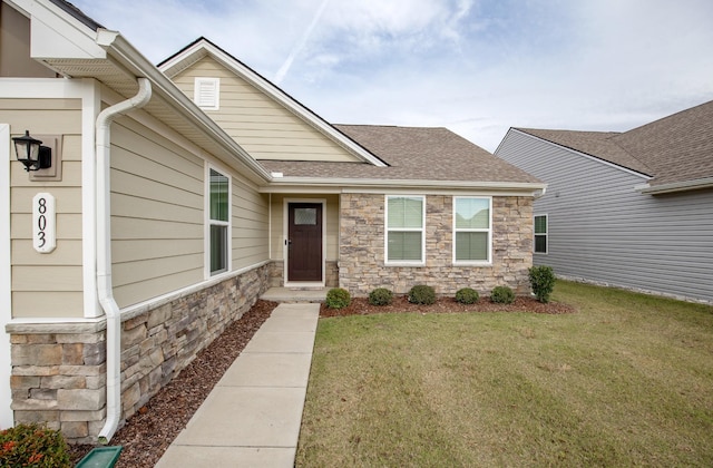 property entrance featuring a lawn