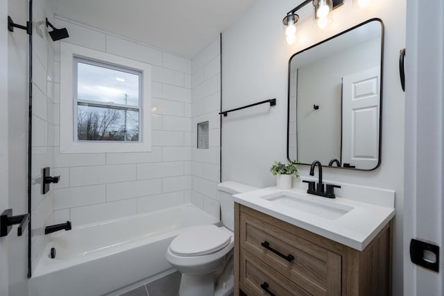 full bathroom with tile patterned flooring, tiled shower / bath combo, toilet, and vanity