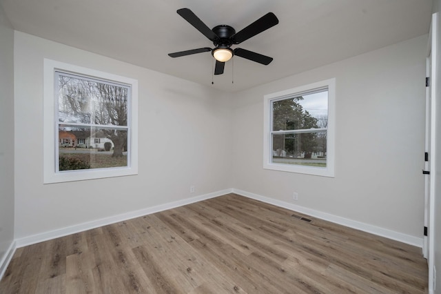 spare room featuring ceiling fan and light hardwood / wood-style floors