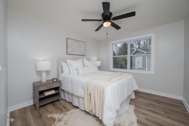 bedroom with ceiling fan and hardwood / wood-style flooring