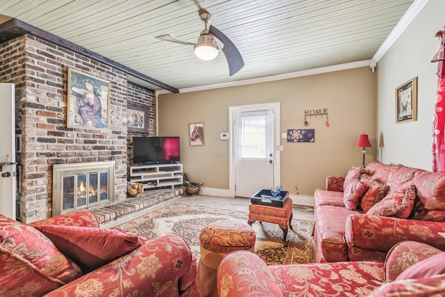 living room featuring a brick fireplace, ceiling fan, and crown molding