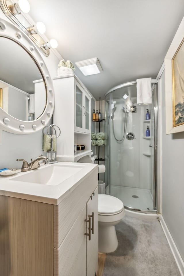 bathroom featuring toilet, vanity, and walk in shower