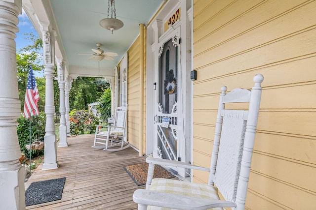 wooden terrace featuring ceiling fan