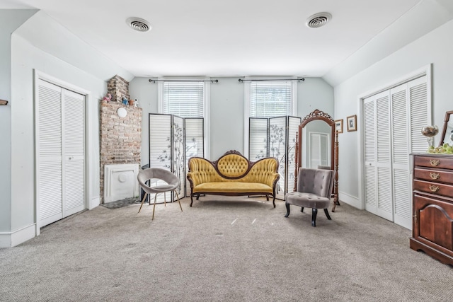 living area featuring light carpet and lofted ceiling