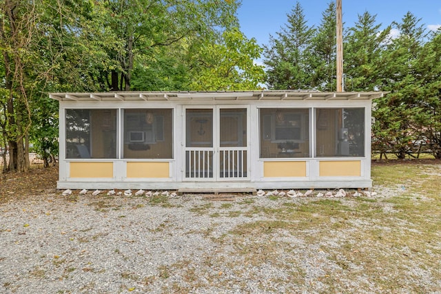 back of house featuring a sunroom