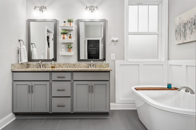 bathroom featuring a washtub, vanity, and tile patterned flooring