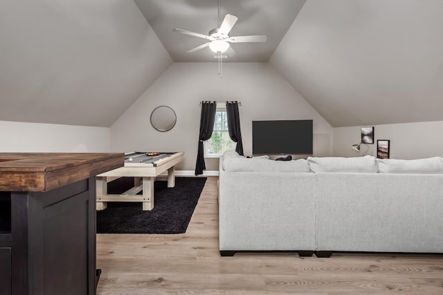 living room with ceiling fan, light hardwood / wood-style flooring, and lofted ceiling