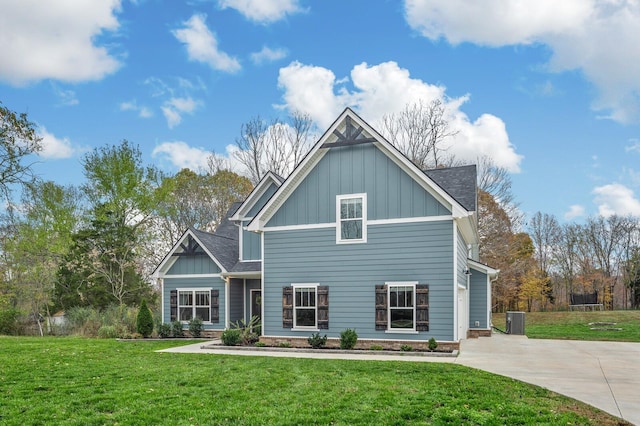 back of house with central AC unit and a lawn