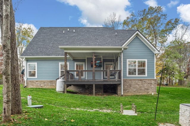 rear view of property with a yard