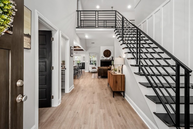 foyer featuring a large fireplace and light hardwood / wood-style flooring