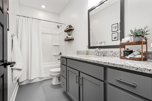 full bathroom featuring tile patterned flooring, vanity, toilet, and shower / bathtub combination with curtain