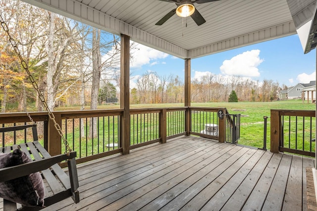 deck with a yard and ceiling fan