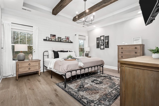 bedroom with a chandelier, beam ceiling, light wood-type flooring, and multiple windows