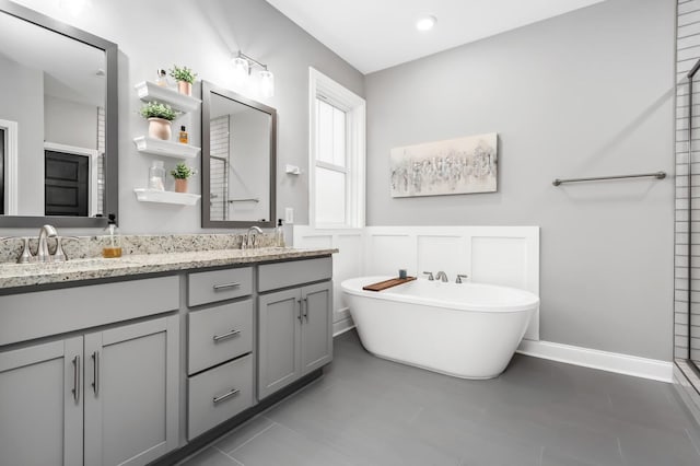 bathroom with vanity, tile patterned floors, and a bathtub