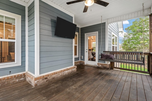 wooden deck featuring ceiling fan