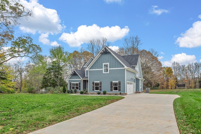 view of front facade with cooling unit, a garage, and a front lawn