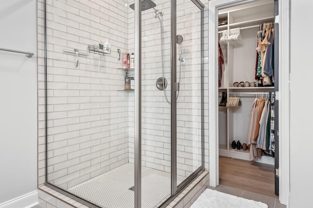 bathroom featuring wood-type flooring and walk in shower