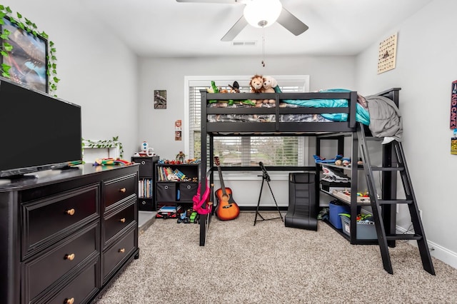 carpeted bedroom featuring multiple windows and ceiling fan