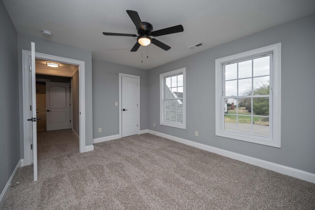 unfurnished bedroom featuring carpet flooring and ceiling fan