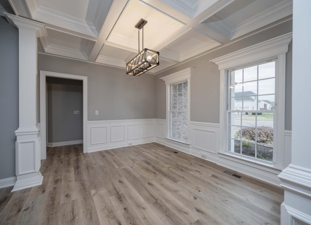 unfurnished dining area featuring beamed ceiling, ornamental molding, and coffered ceiling