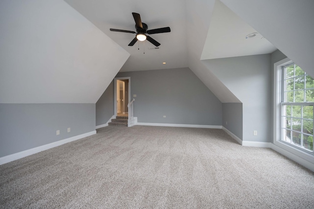 additional living space featuring carpet, ceiling fan, and lofted ceiling