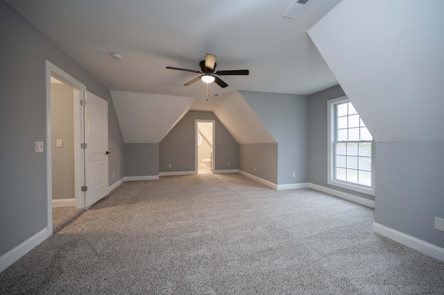 additional living space with light carpet and ceiling fan