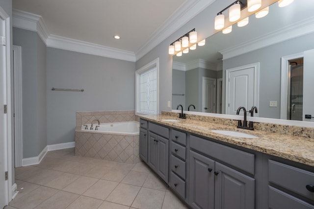 bathroom featuring tile patterned floors, vanity, crown molding, and tiled bath