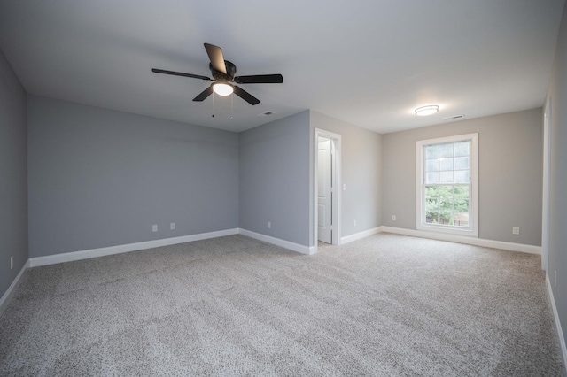 carpeted empty room featuring ceiling fan