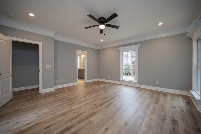 interior space with ceiling fan, light hardwood / wood-style floors, ornamental molding, and ensuite bathroom