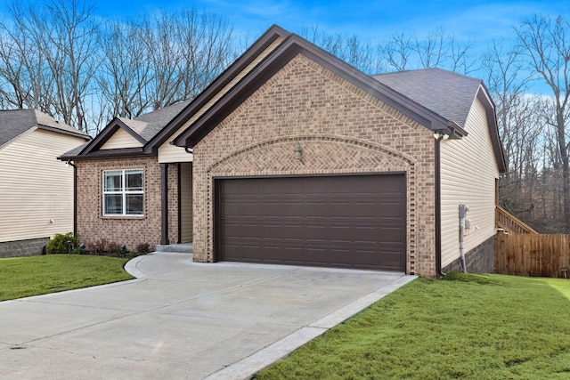 view of front of house featuring a front lawn and a garage