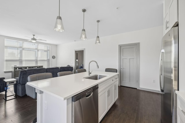 kitchen featuring a kitchen island with sink, sink, white cabinets, and stainless steel appliances