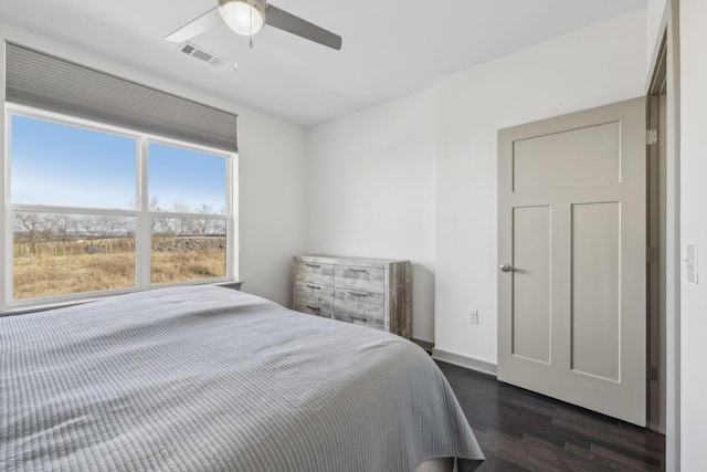 bedroom with ceiling fan and dark hardwood / wood-style floors