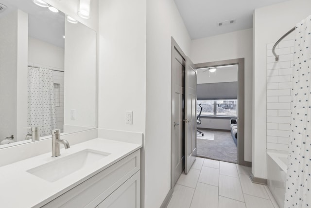 bathroom featuring tile patterned floors, vanity, and shower / tub combo with curtain