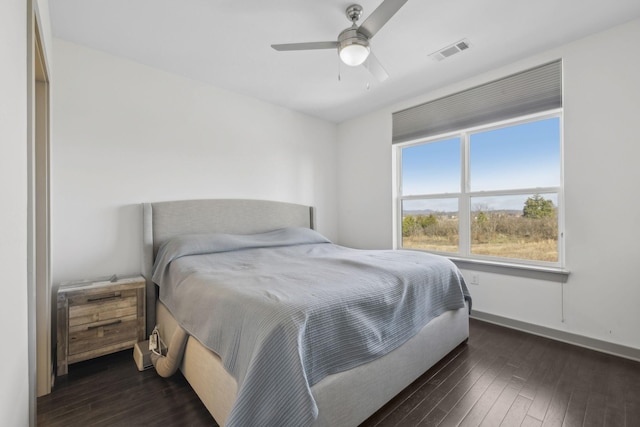 bedroom with ceiling fan and dark hardwood / wood-style floors