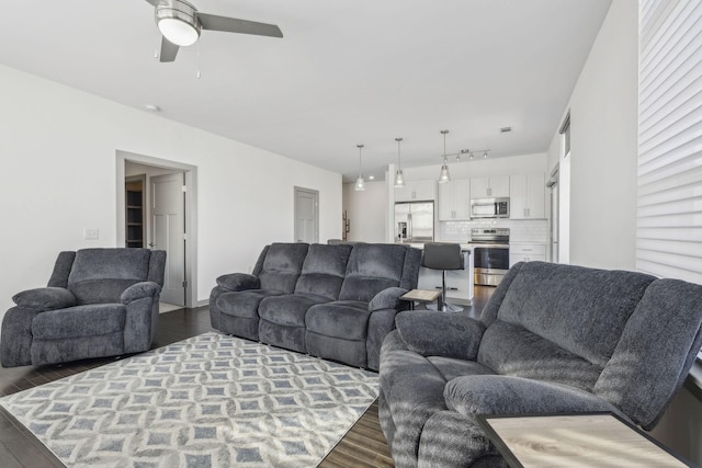 living room with ceiling fan and hardwood / wood-style floors