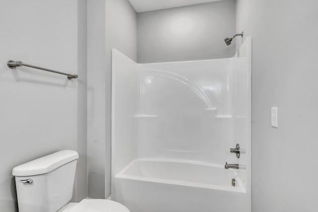 bathroom featuring shower / bathing tub combination and toilet