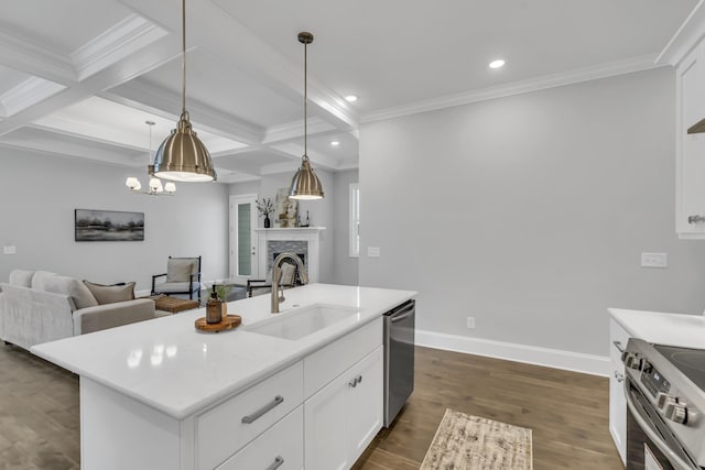 kitchen featuring stainless steel appliances, coffered ceiling, an island with sink, pendant lighting, and white cabinets