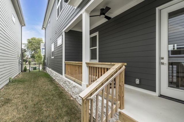 exterior space featuring a lawn and ceiling fan