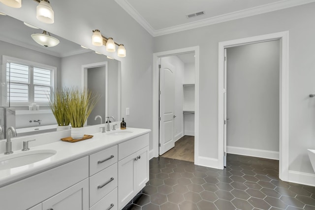 bathroom with vanity, tile patterned floors, and crown molding