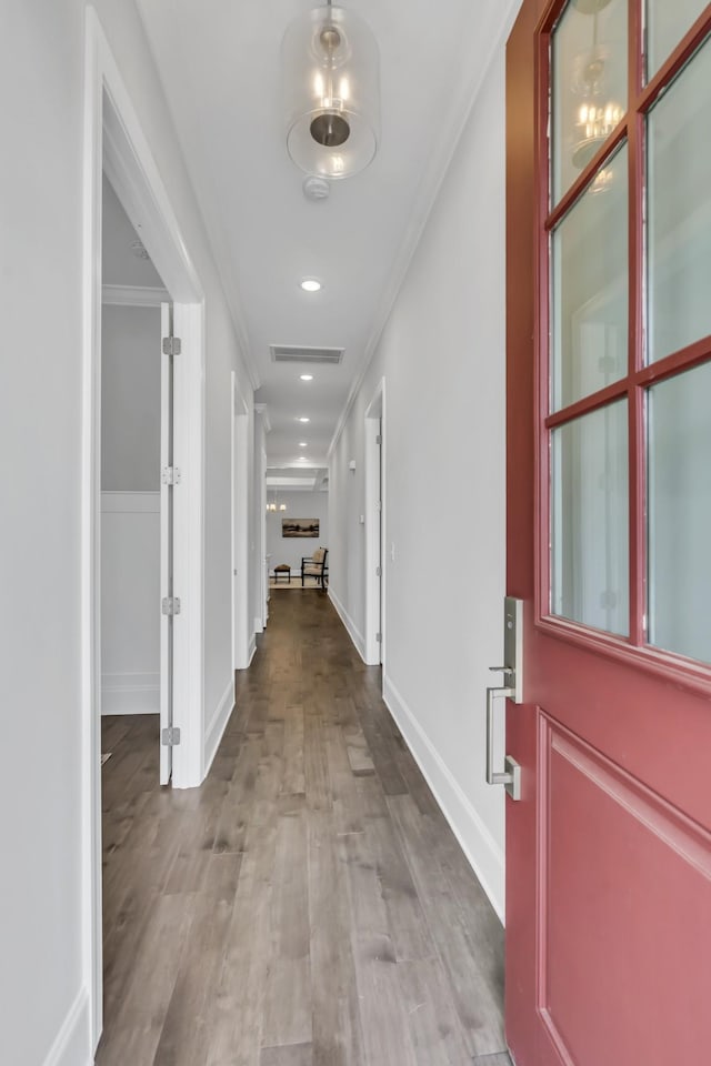 corridor featuring light hardwood / wood-style flooring and ornamental molding