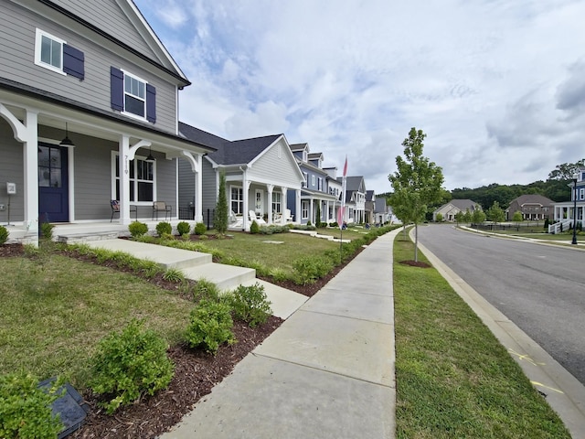 exterior space with covered porch and a front yard