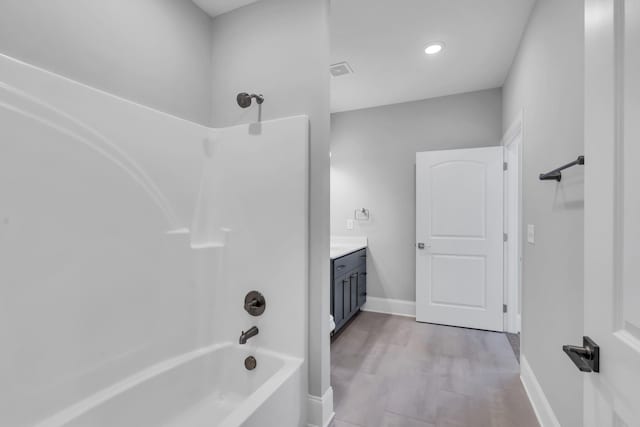 bathroom with bathing tub / shower combination and vanity