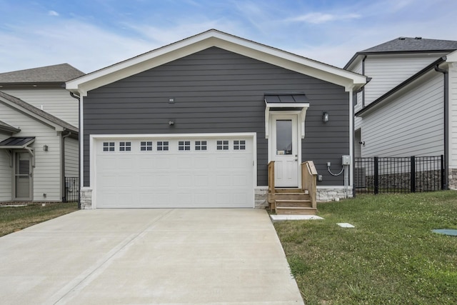 view of front of house with a front lawn and a garage